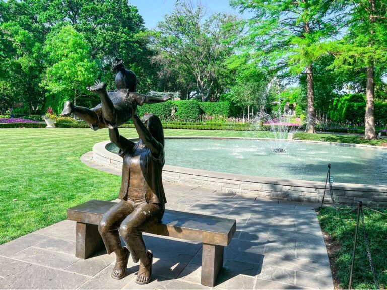 Statue of mother lifting child at Dallas Arboretum and Botanical Garden