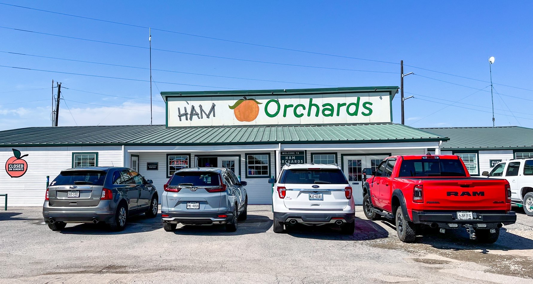 Four parked cars in front of the Ham Orchards store, one of the Dallas Farms locations near Dallas, Texas