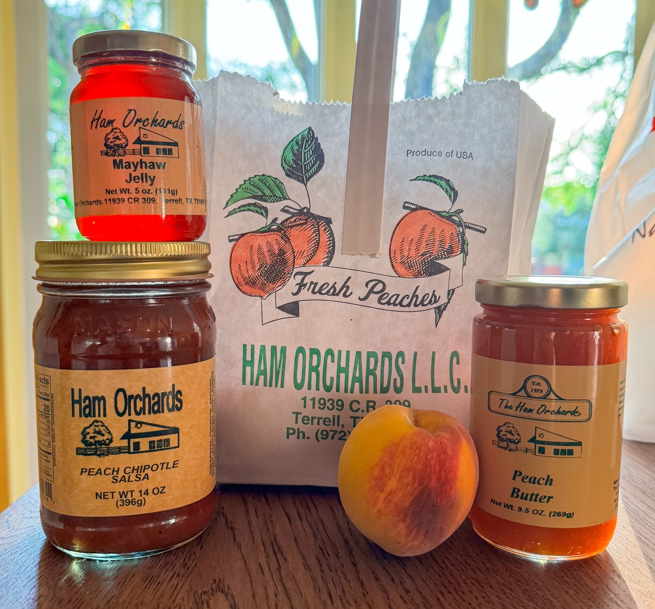 Peach products for sale at Ham Orchards, including peach salsa, peach jelly, peach butter, and fresh peaches