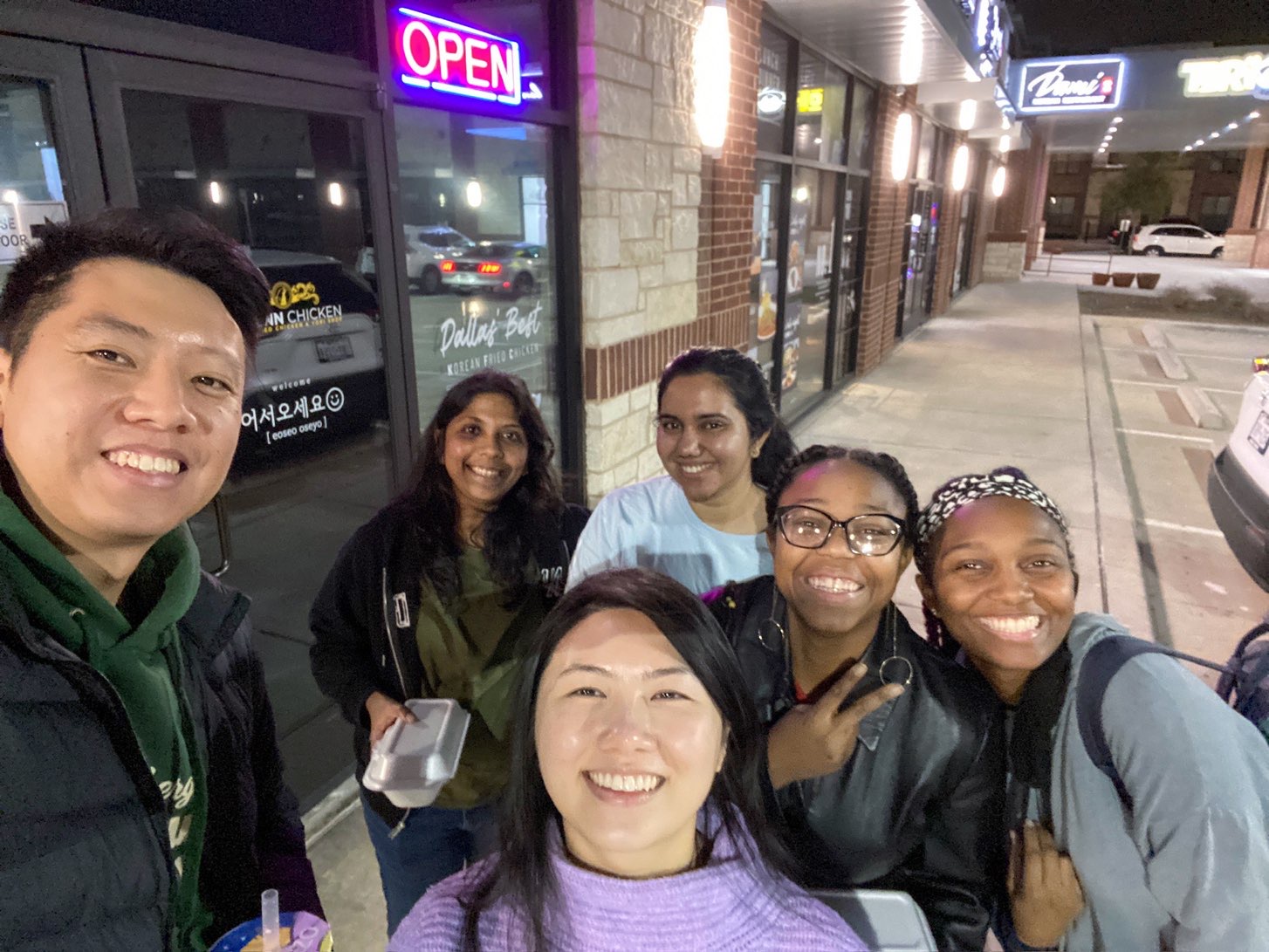 Friends together outside a Dallas store after a fun outing dessert cafe excursion on a Dallas itinerary
