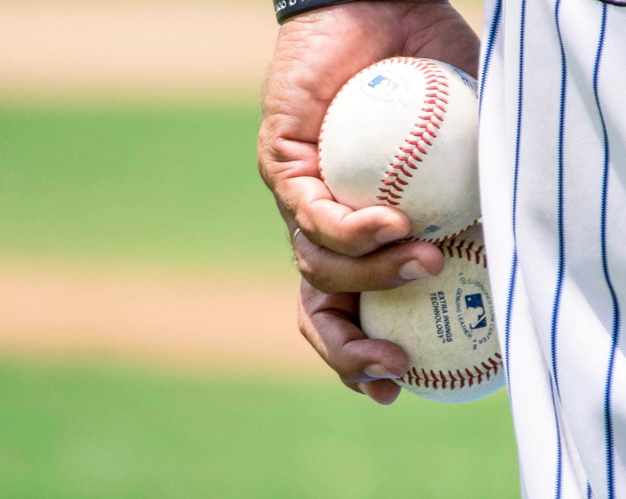 Player holding two baseballs at dallas baseball game