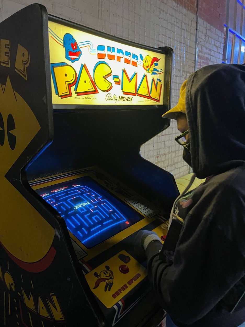 young lady playing pac man at the dallas arcade bar, Round Two