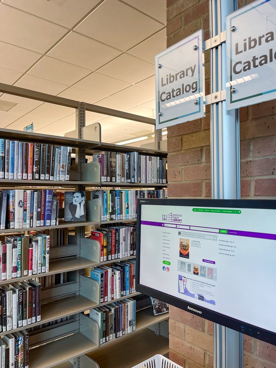 Row of book shelves filled with books at the Lewisville branch library.