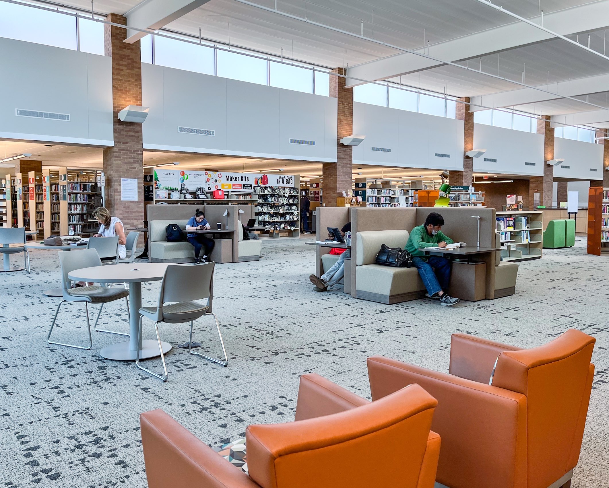 Individuals working and reading at Lewisville branch library