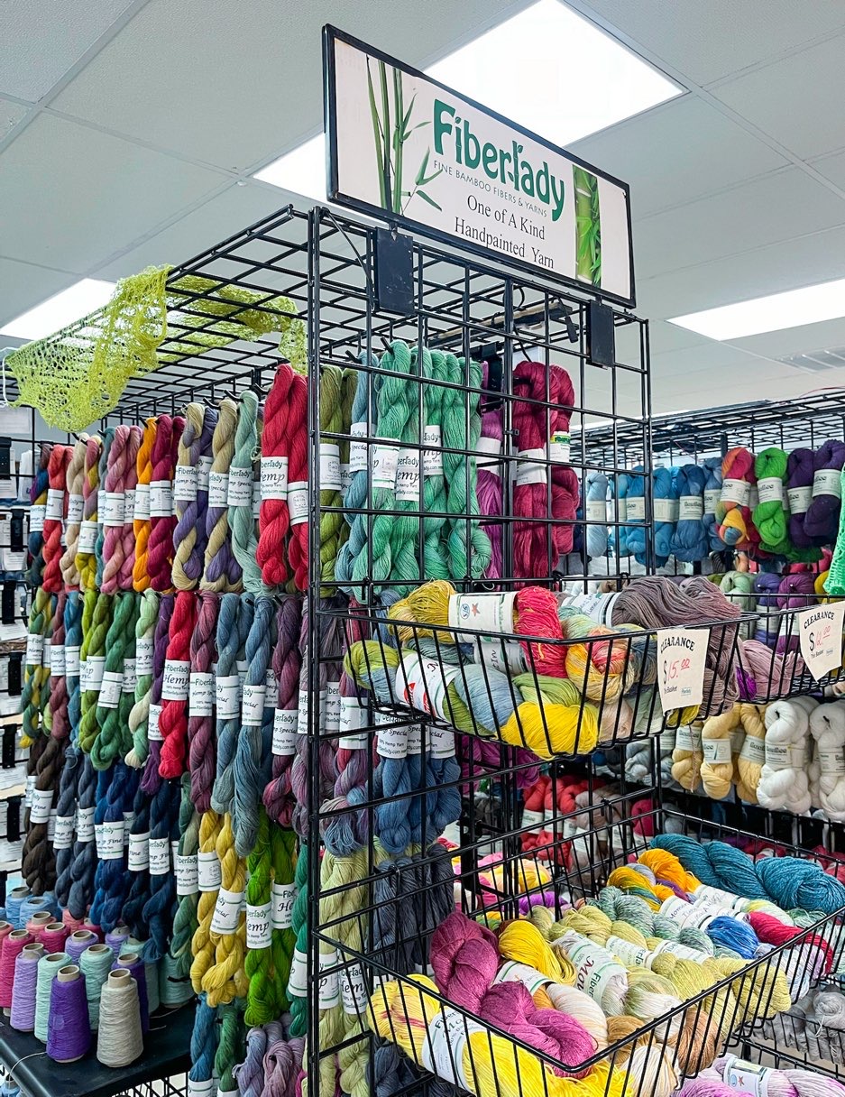 Rack of multi colored hanging yarn skeins at Fiberlady yarn shoppe