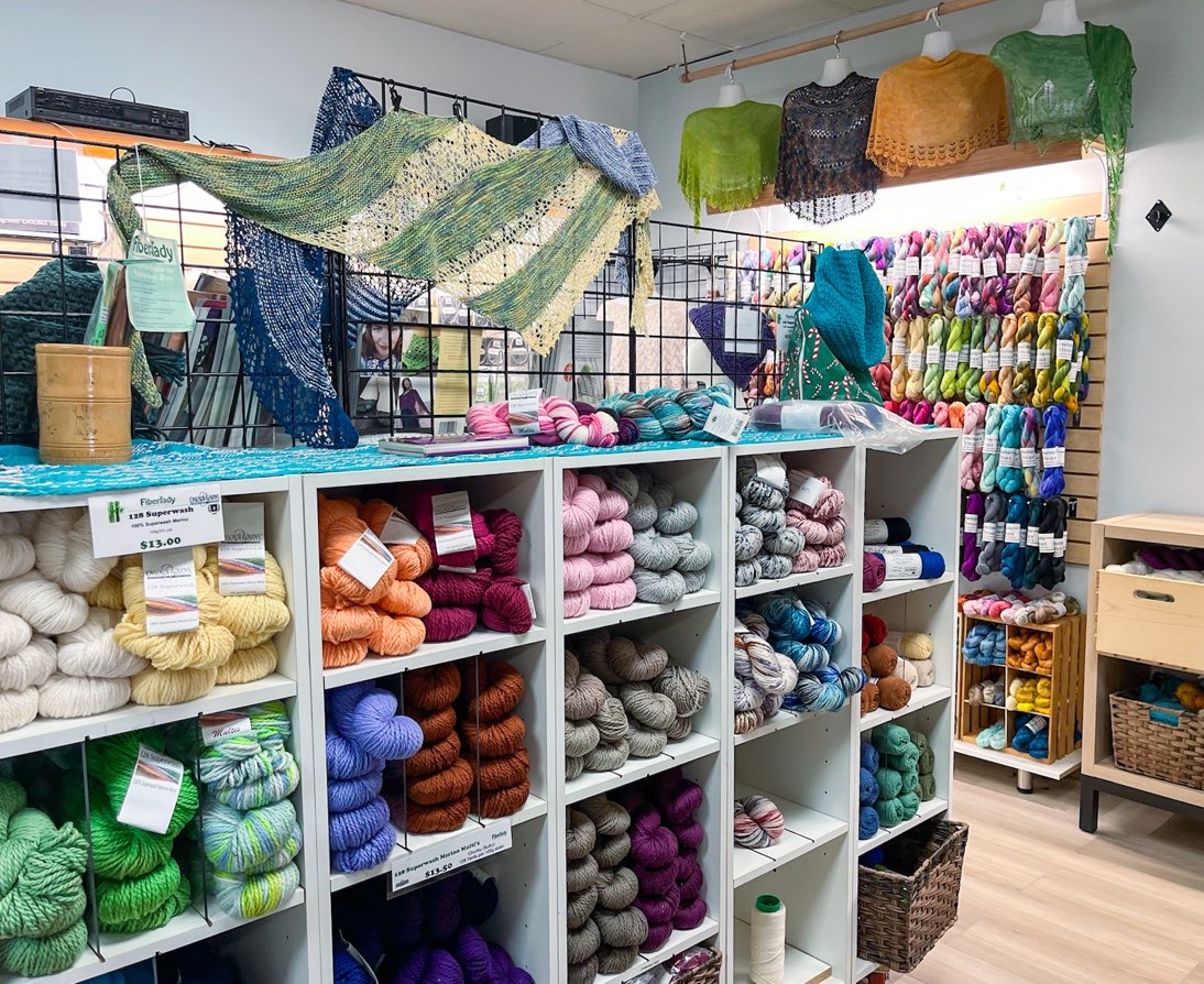 Eye-catching display of knitting yarns and knitted items at Fiberlady yarn store; fiber fest