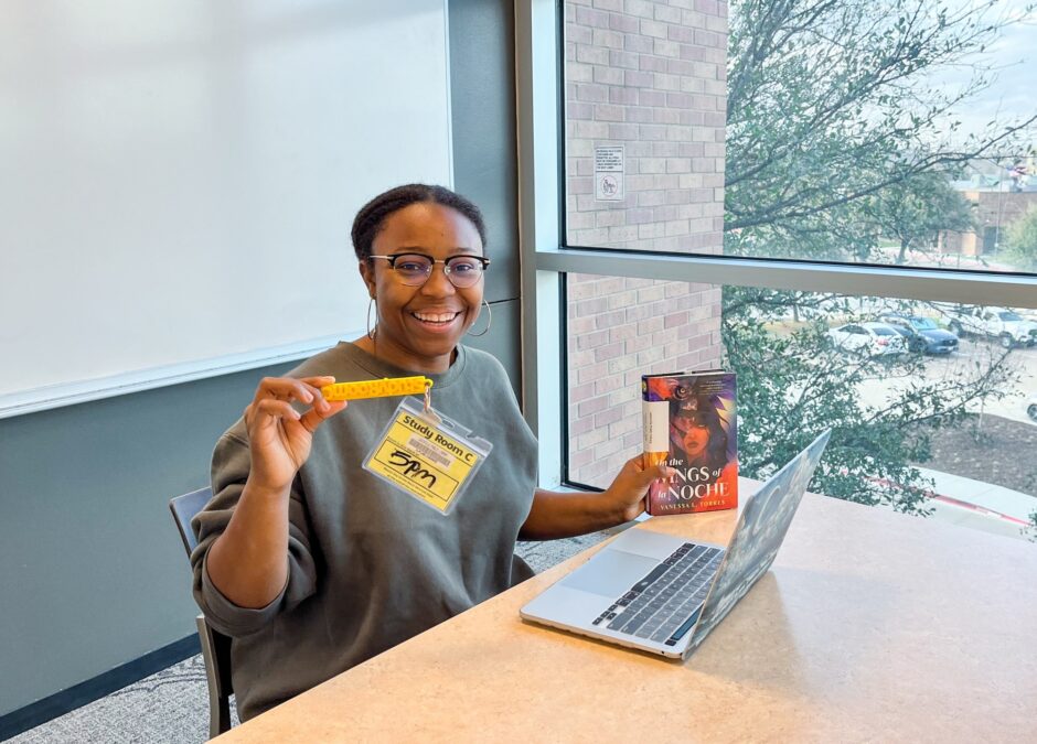 young lady holding key to reserved room at Lewisville branch library