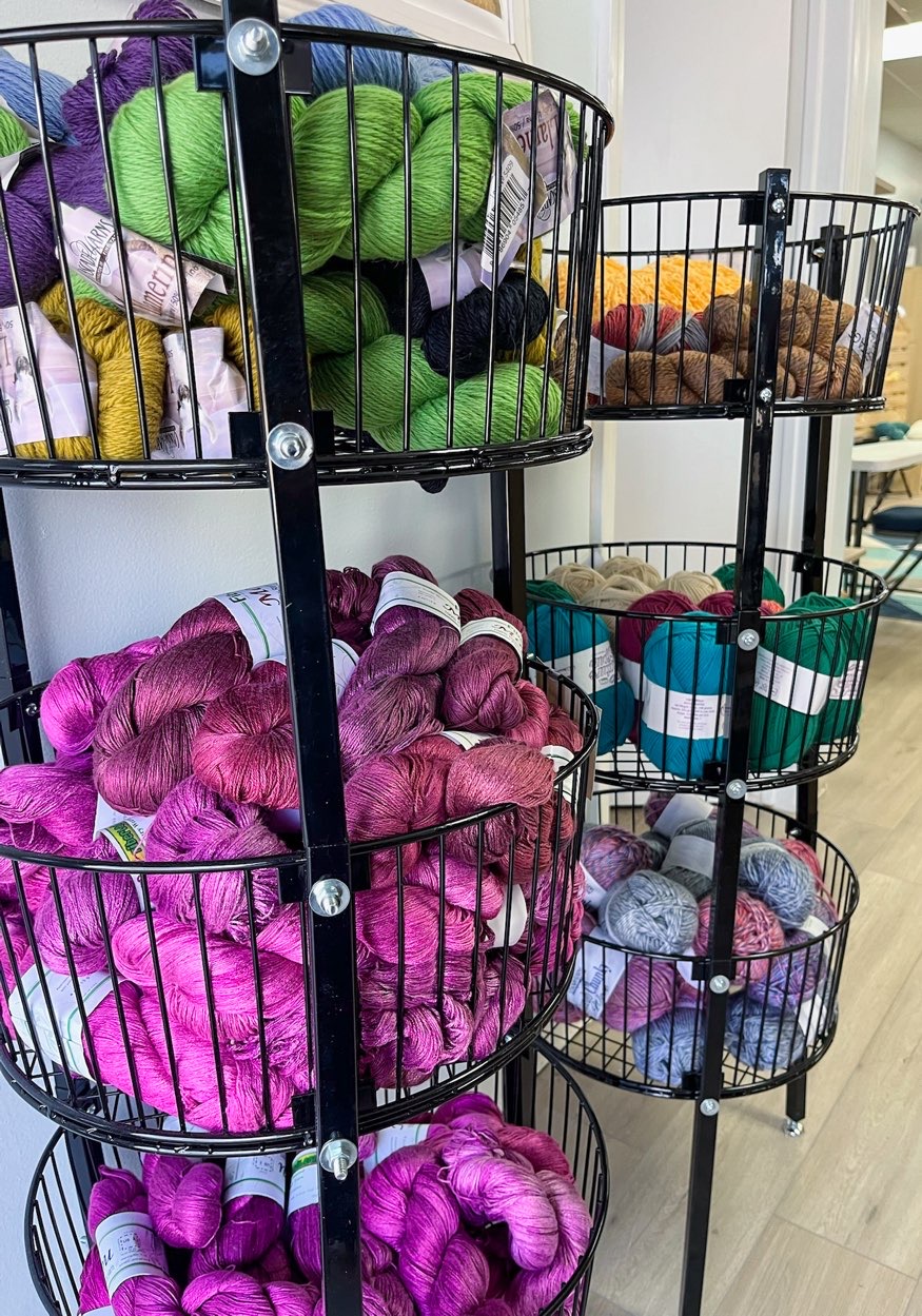 baskets of vibrantly colored yarn skeins on display during north texas yarn crawl