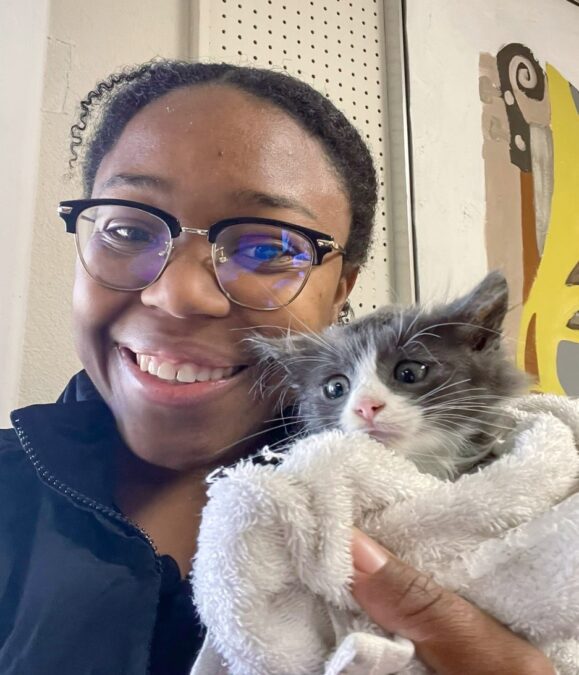 girl holding kitten at cat cafe dfw