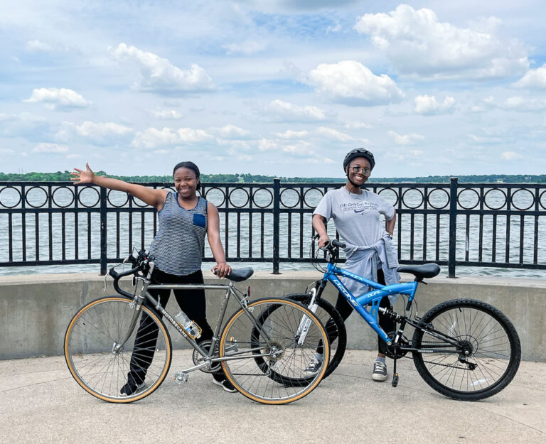 Two young ladies stopping during a bike ride at White rock lake trail for a photo. Another reason why Dallas is worth visiting.