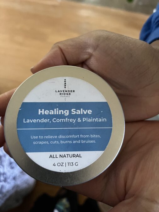 Cupped hands holding a tin of lavender salve at Lavender Ridge Farms.