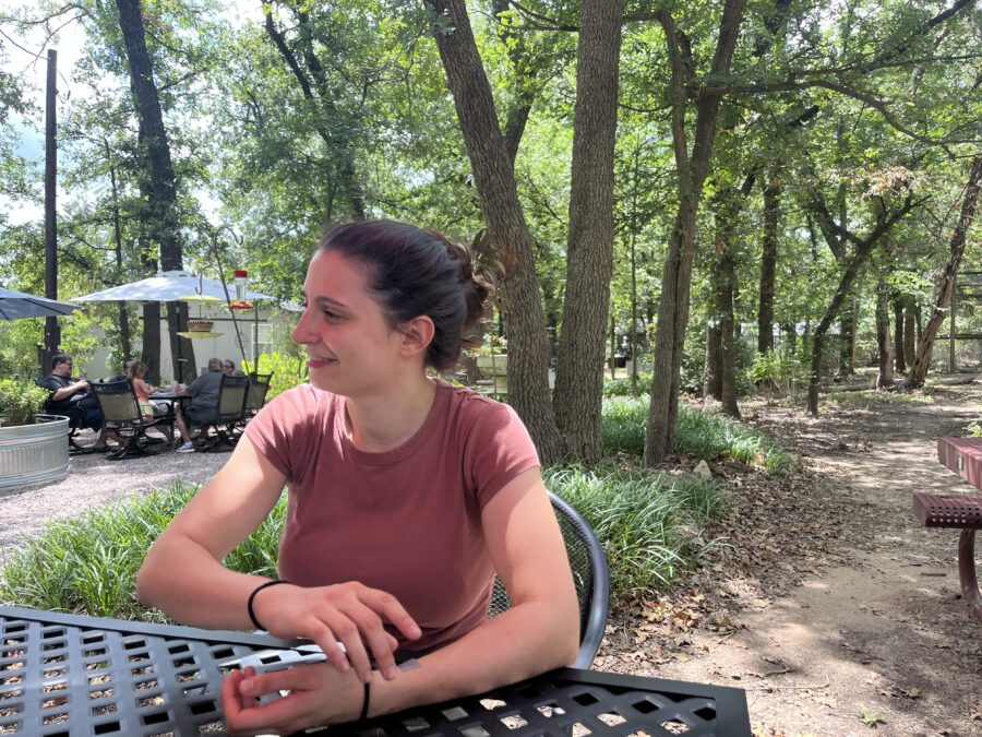 A woman smiling while seated at a table at Lavender Ridge Farms.