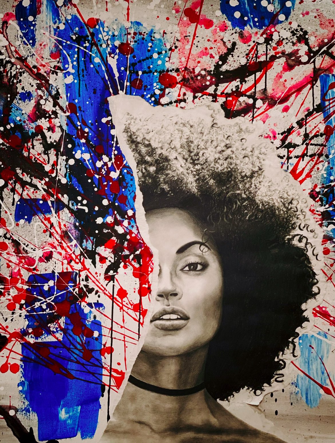 Painted black-and-white portrait of a young Black woman with a large afro, partially obscured by red, white, and blue splattered masking, at the African American Museum of Dallas, one of the free things to do in Dallas with kids.