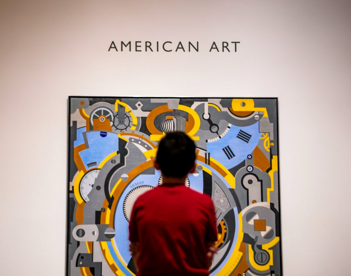 Young boy studying a piece of American art at one of the free museums in Dallas.