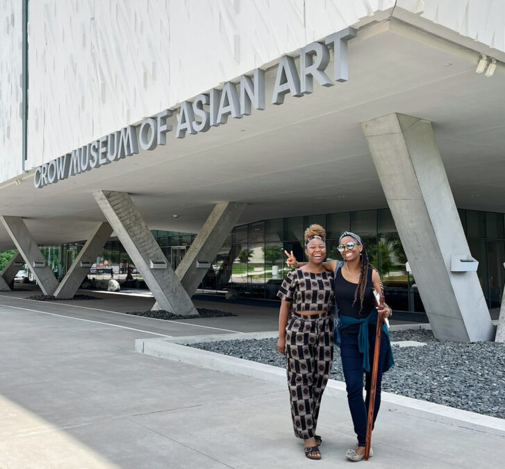 Two young women pose outside the Crow Museum of Asian Art, one of the many indoor activities in Dallas