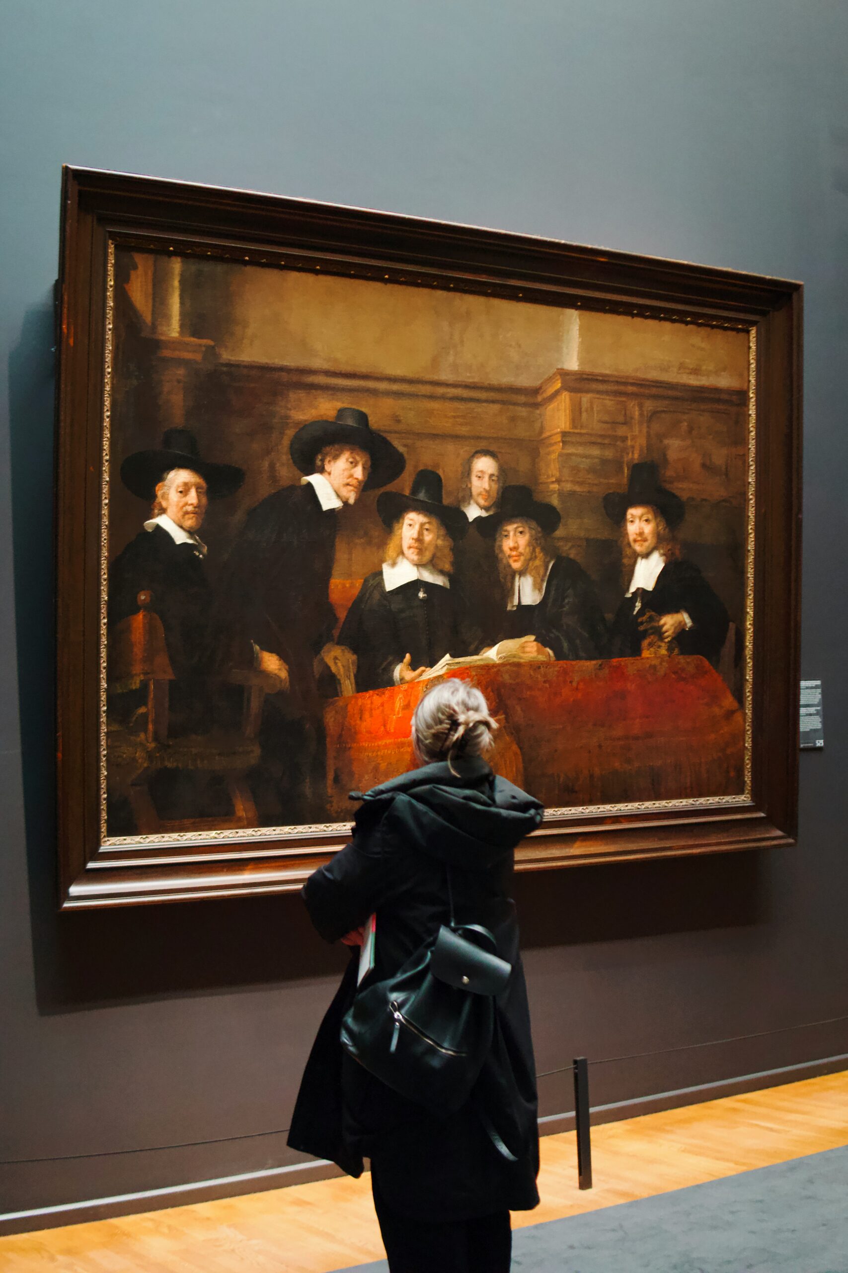 Young lady standing and observing painting of European art at Kimbell Art Museum - one of the free museums near Dallas