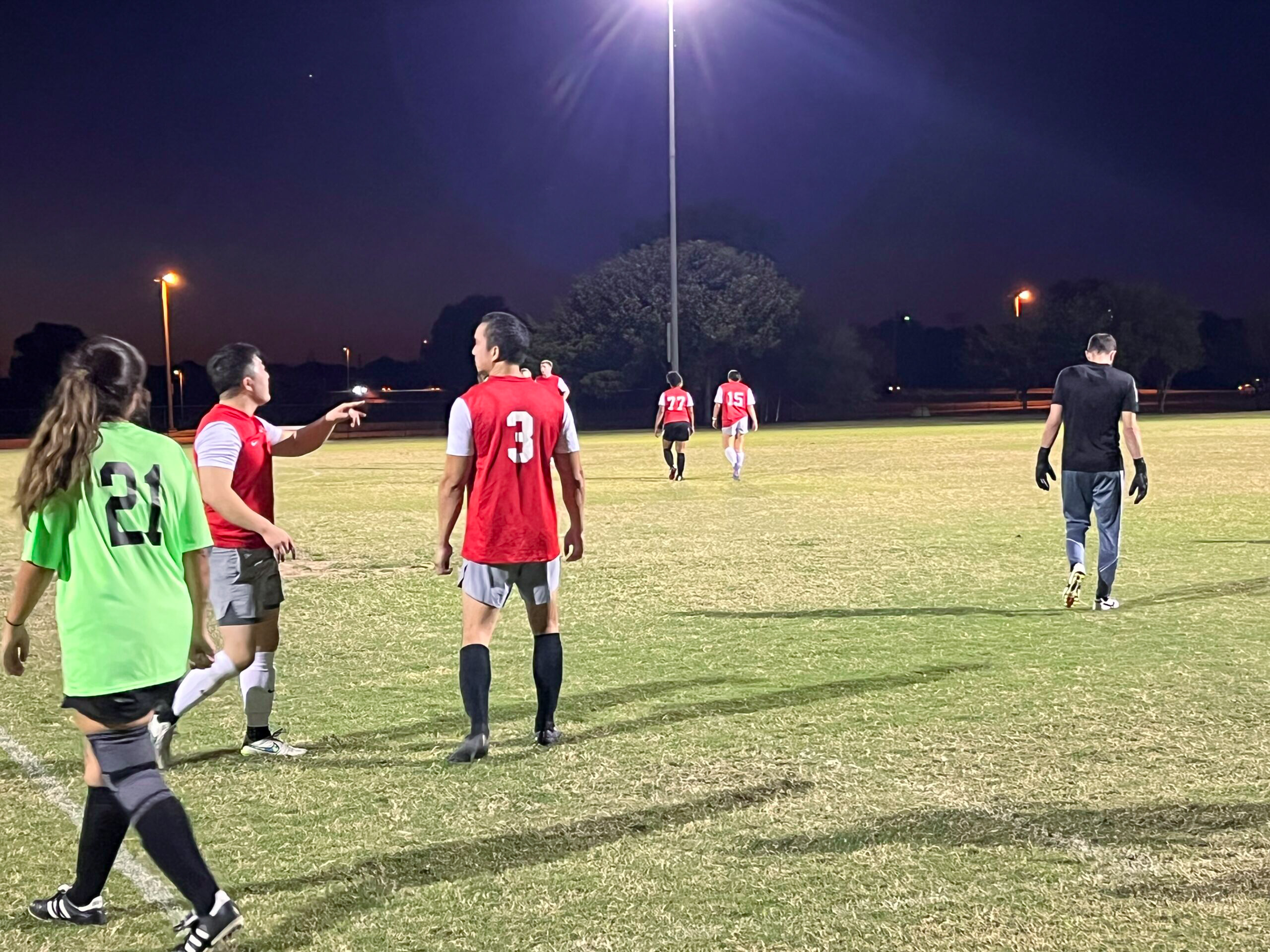 Adult teams playing a competitive soccer game in Dallas sports leagues through North Texas Soccer Association