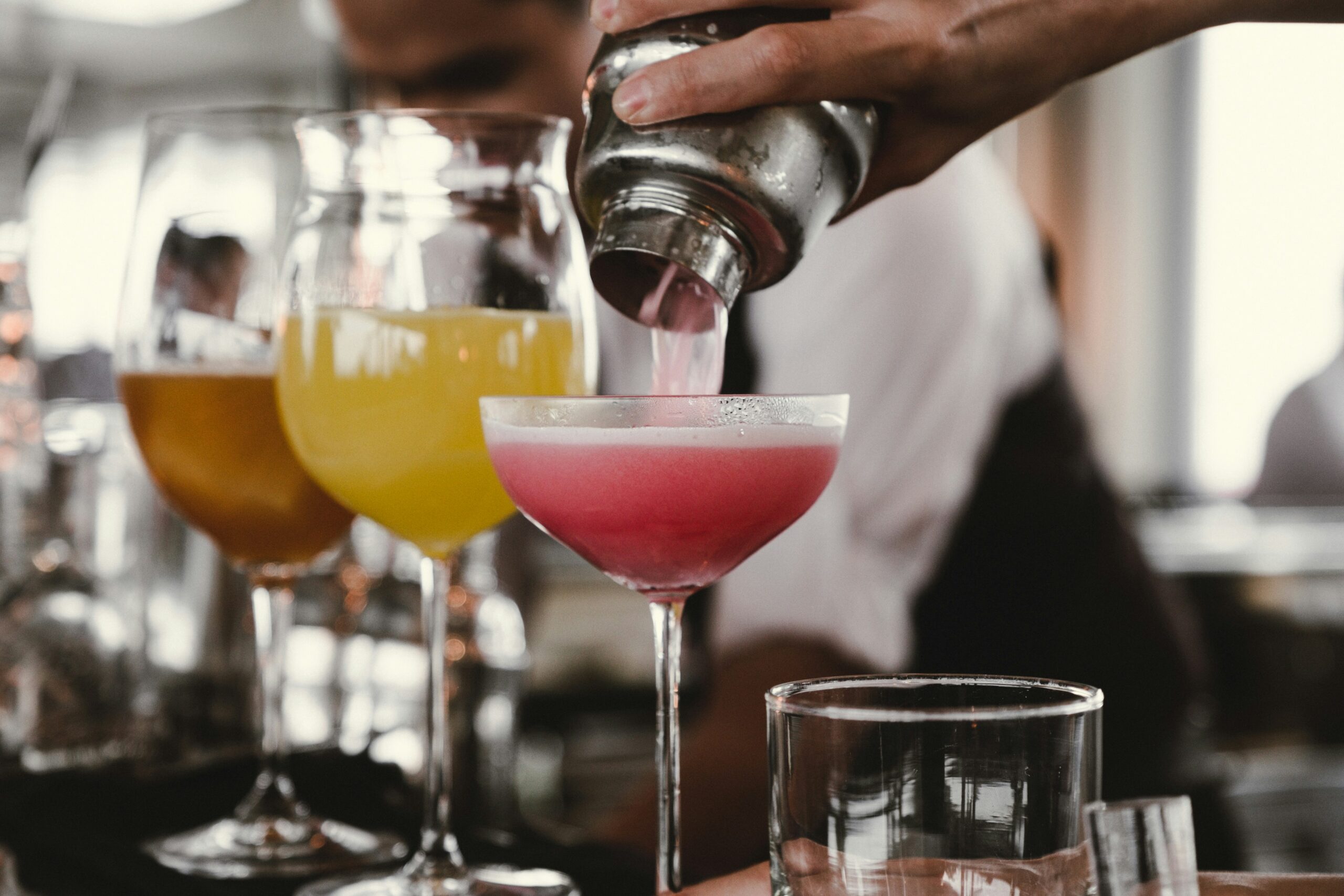Mixed cocktails being stirred up at a local bar in Deep Ellum, generally with no cover charge, and included on the list of free things to do in Dallas at night.