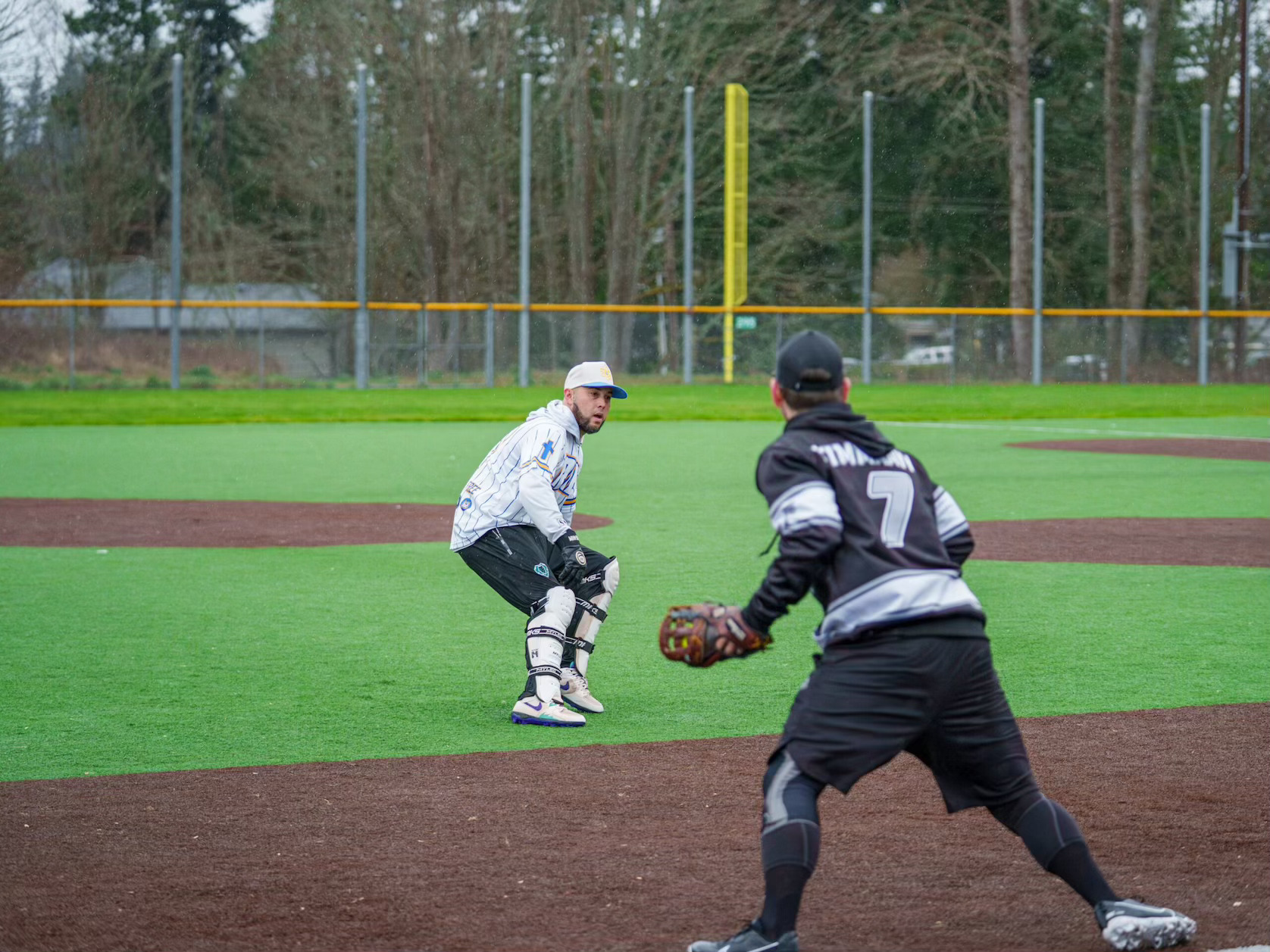 Adult players on a baseball diamond anticipating a play, highlighting Dallas sports leagues and social team sports in Dallas