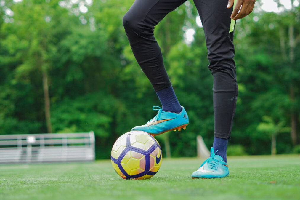 Goalie stops a soccer ball with cleat during a match in one of the many Dallas sports leagues for adults and recreational players.