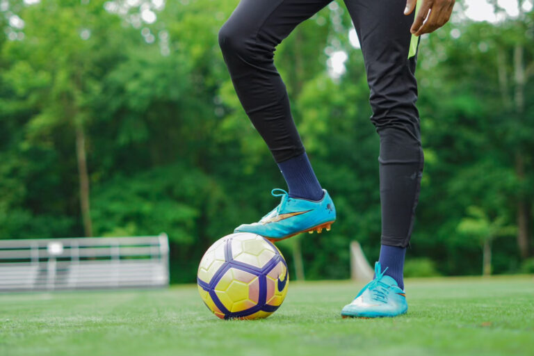 Goalie stops a soccer ball with cleat during a match in one of the many Dallas sports leagues for adults and recreational players.