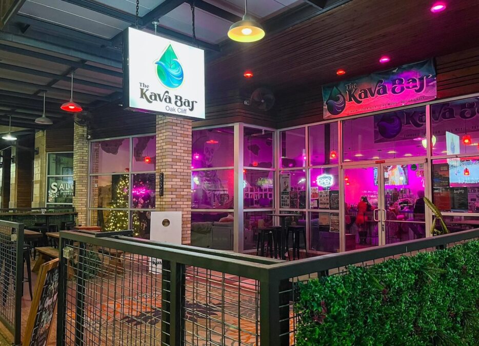 Kava Bar patio with outdoor seating and an inviting pink-lit interior, one of the coffee shops open late in Dallas.