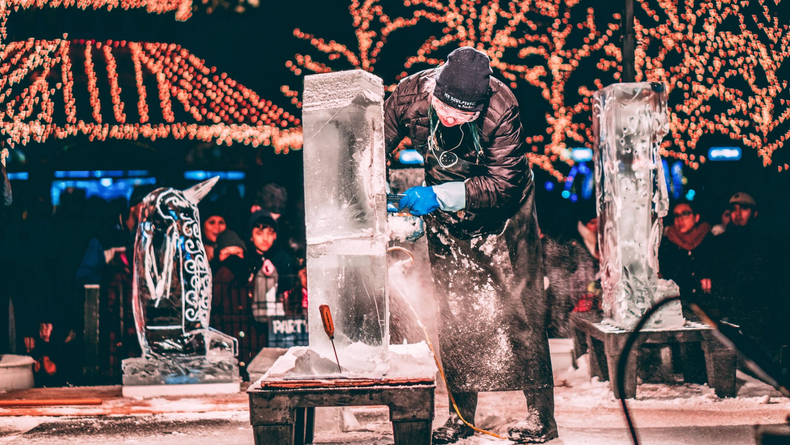 Ice sculptor carves a frozen artwork for the ICE attraction during Christmas in Grapevine.