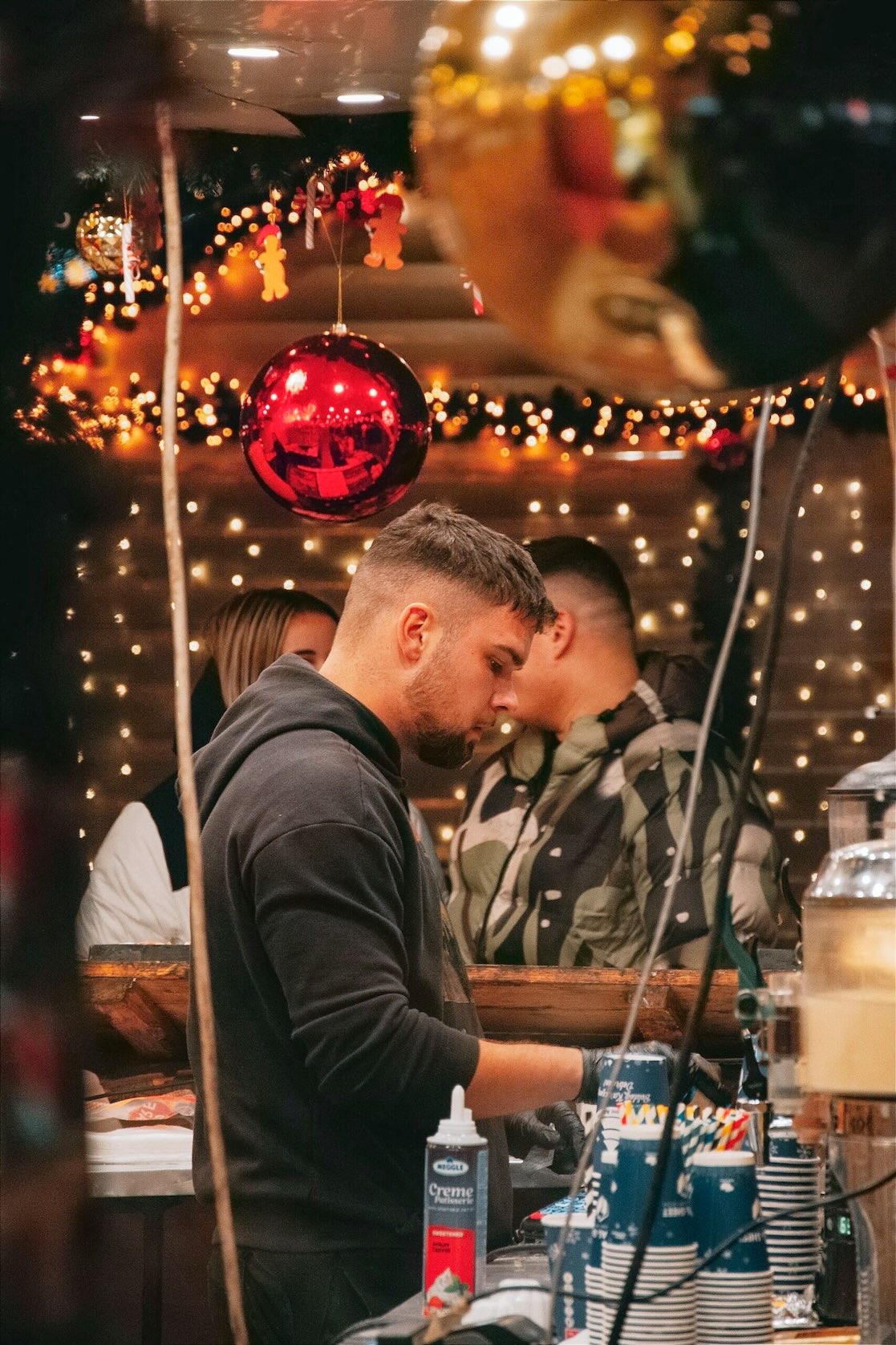 A young barista serves coffee from an outdoor coffee stand during Christmas in Grapevine.
