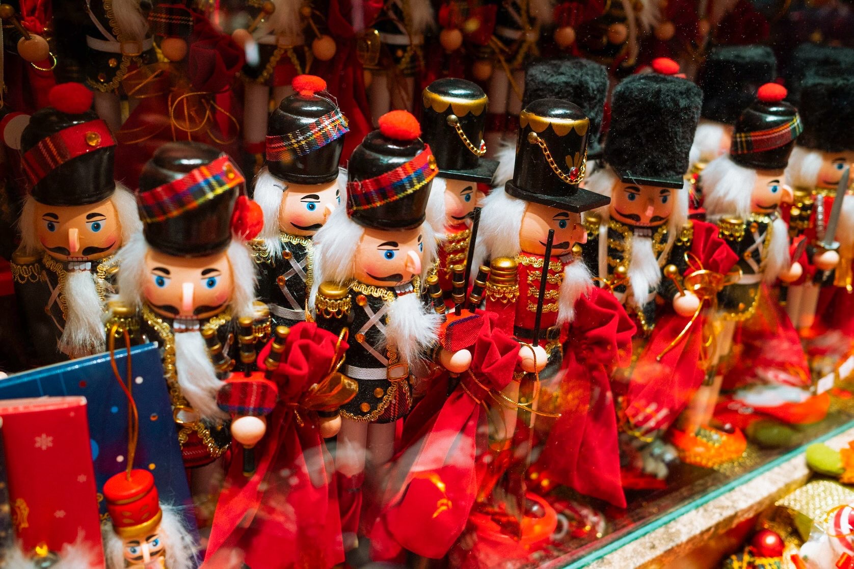 Winter in Dallas featuring two rows of colorful soldier nutcrackers in red and green coats with gold trim, tall hats, and red bows, creating a festive holiday display.