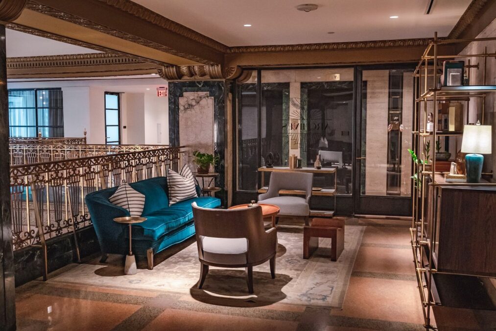 Welcoming interior of the Adolphus Hotel featuring elegant sofas and chairs in an inviting upstairs seating area during winter in Dallas.