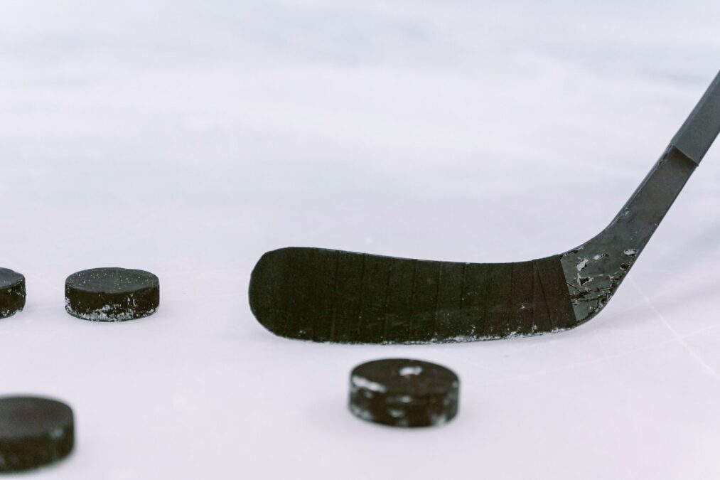 Hockey puck and stick blade representing the excitement of a Dallas Stars game during winter in Dallas.