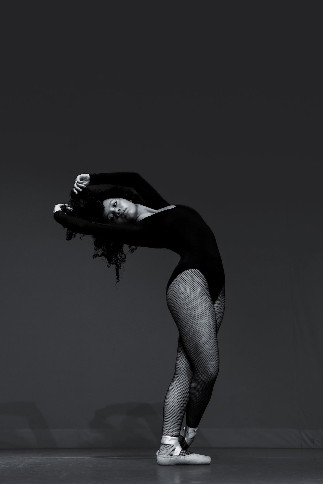 Female dancer poses gracefully during an introspective dance performance in Dallas