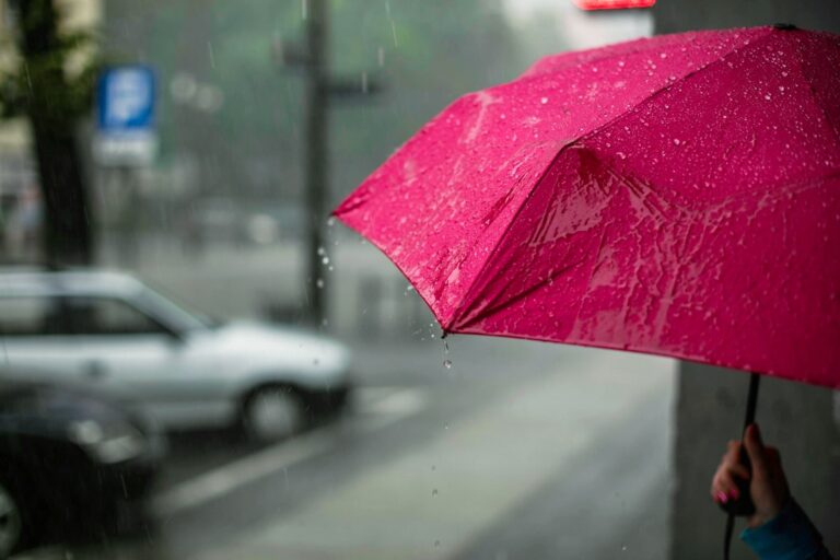 Red umbrella sheds raindrops on a rainy Dallas day, inspiring indoor activities in Dallas