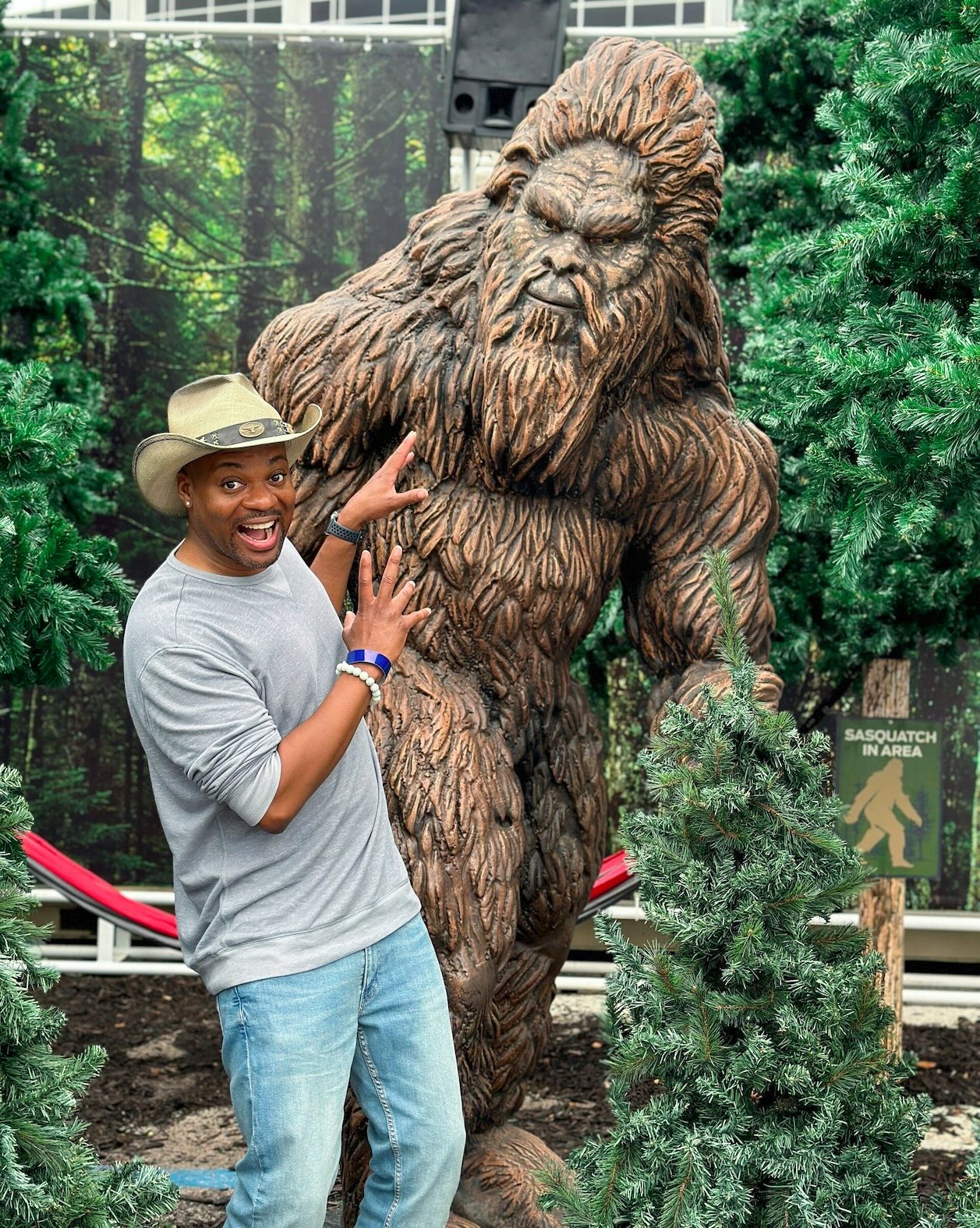 Young man reacts with mock fear beside a life-size Bigfoot replica in a forest setting The North American Cryptid Museum in Plano houses a life-size Bigfoot replica, one of the unique-things-to-do-in-dfw.