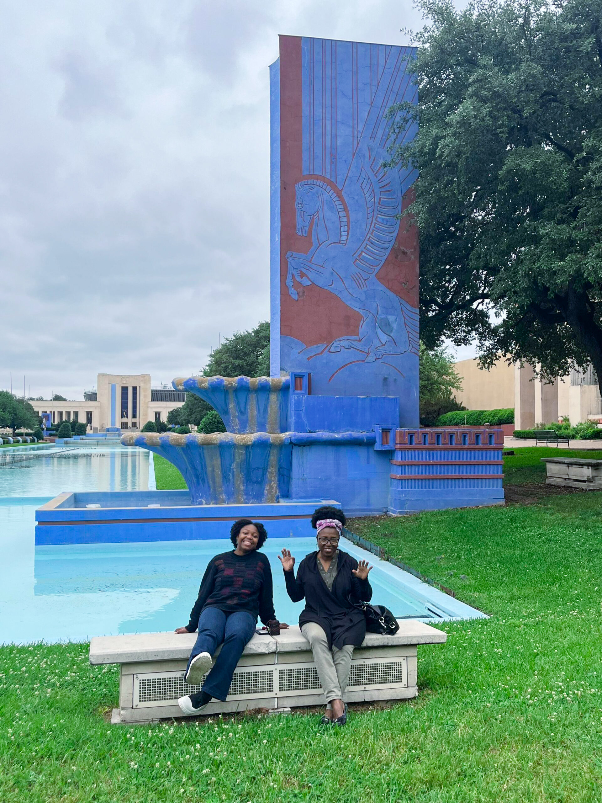 Visitors relax beside the 700-foot Esplanade reflecting pool and fountains at Fair Park, a historic 1936 Texas Centennial site and one of the unique-things-to-do-in-dfw.