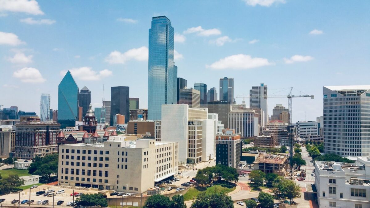 Downtown Dallas skyline with varied high-rise buildings, city streets, and light traffic, a scenic backdrop for free things to do in Dallas for couples